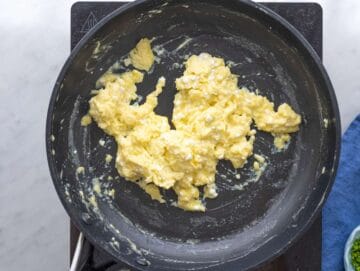 Step 2 Eggs gently cooking in nonstick pan, soft curds forming with spatula.