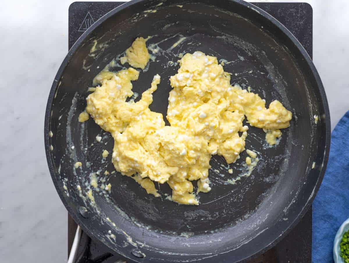 Step 2 Eggs gently cooking in nonstick pan, soft curds forming with spatula.