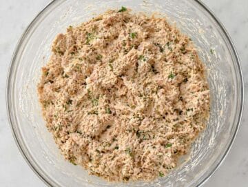 Step 2 Tuna mixture being mashed with yogurt, tahini, and herbs until creamy.