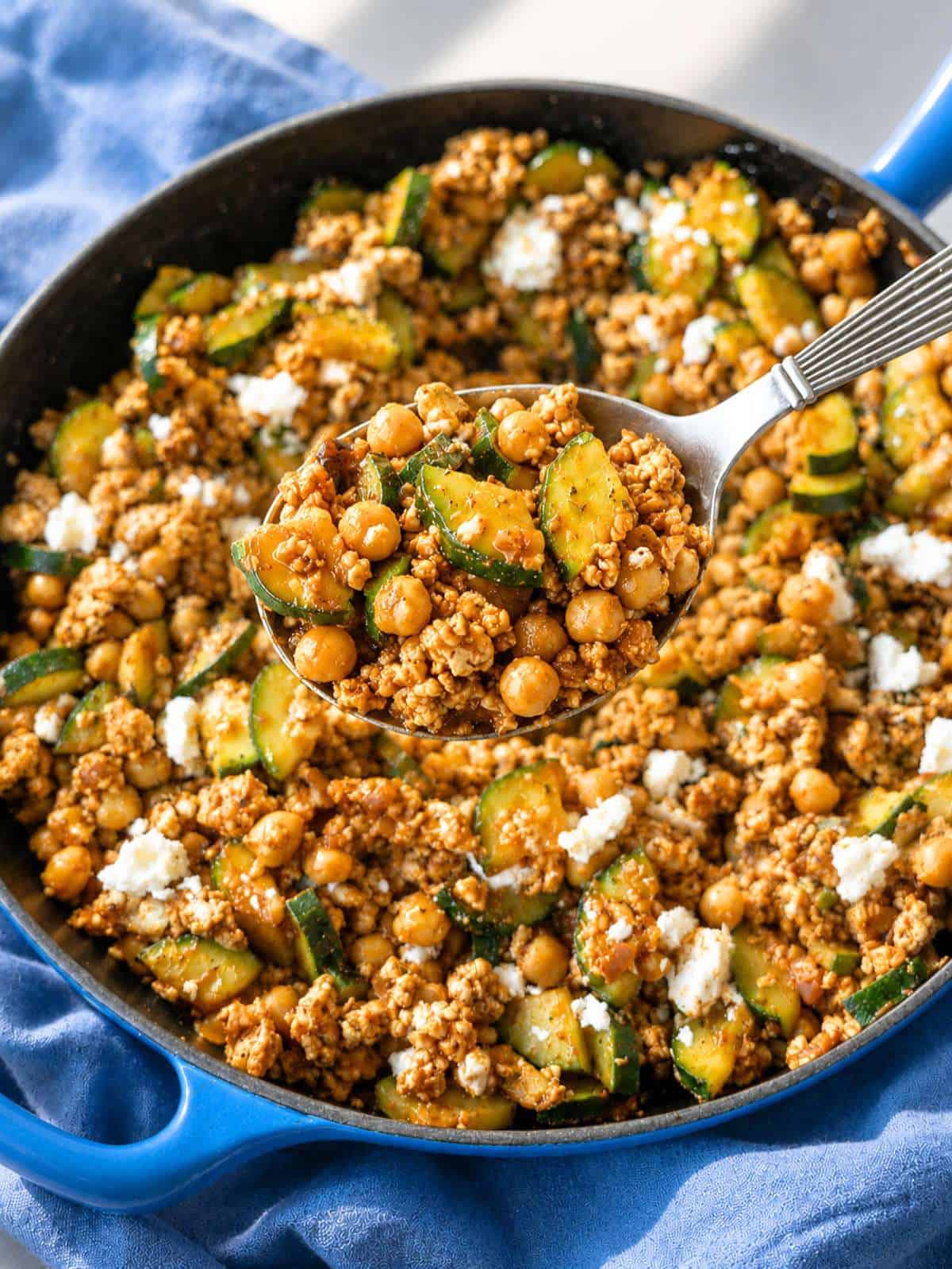 Close-up of juicy turkey, chickpeas, and feta in Greek ground turkey skillet.