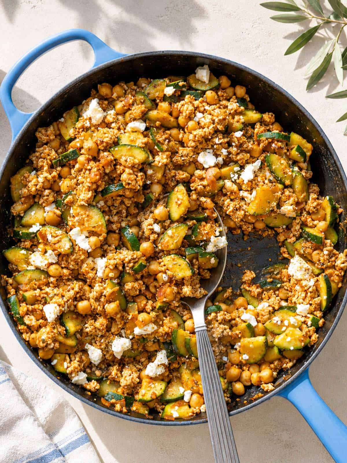 Greek ground turkey skillet with zucchini, chickpeas, and feta in natural light.