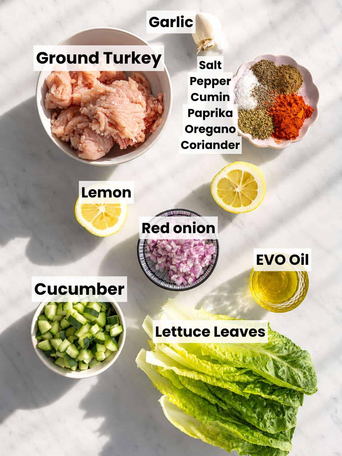 Ingredients for Turkey Lettuce Wraps with ground turkey, spices, yogurt sauce, cucumber, feta, and lettuce.
