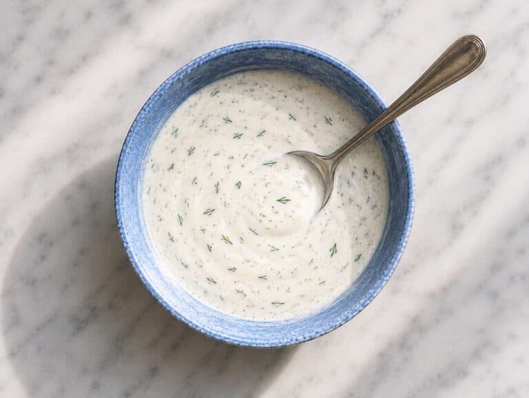 Step 1 Greek yogurt sauce with dill, garlic, lemon, and olive oil whisked in a small bowl.