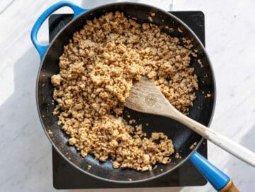 Step 1 Ground turkey browning in skillet with paprika and cumin on marble countertop.