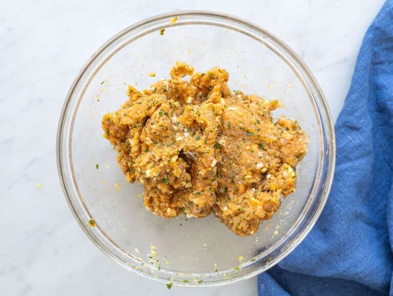 Step 1 Ground turkey mixture with feta, herbs, garlic, and spices mixed in glass bowl.