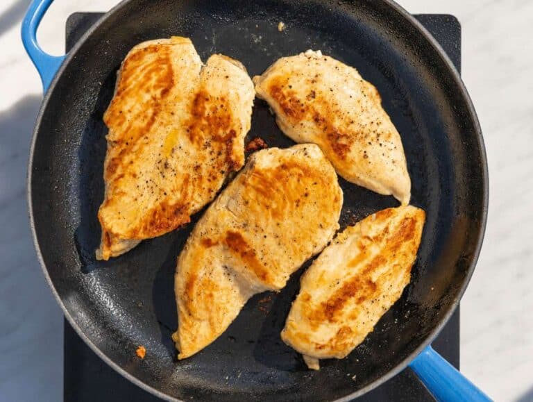 Step 1 Seasoned chicken cutlets searing in a skillet until golden brown.