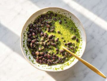 Step 2 Black beans soaking in cilantro lime dressing in porcelaine mixing bowl.