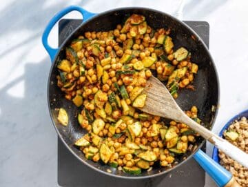 Step 2 Zucchini, red onion, and chickpeas cooking in large skillet with olive oil.