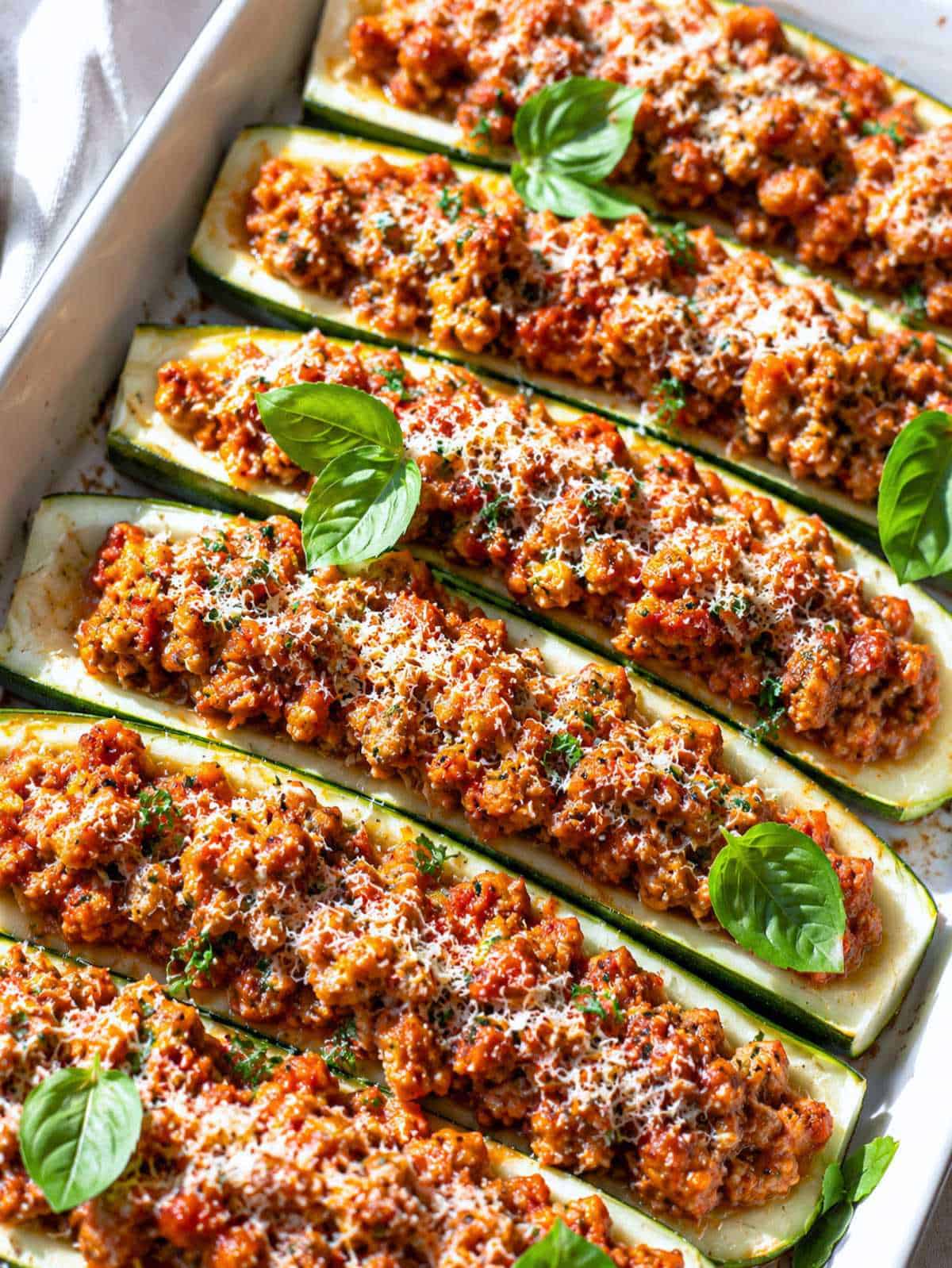 Close-up of turkey zucchini boat filled with savory marinara turkey and melted Parmesan.