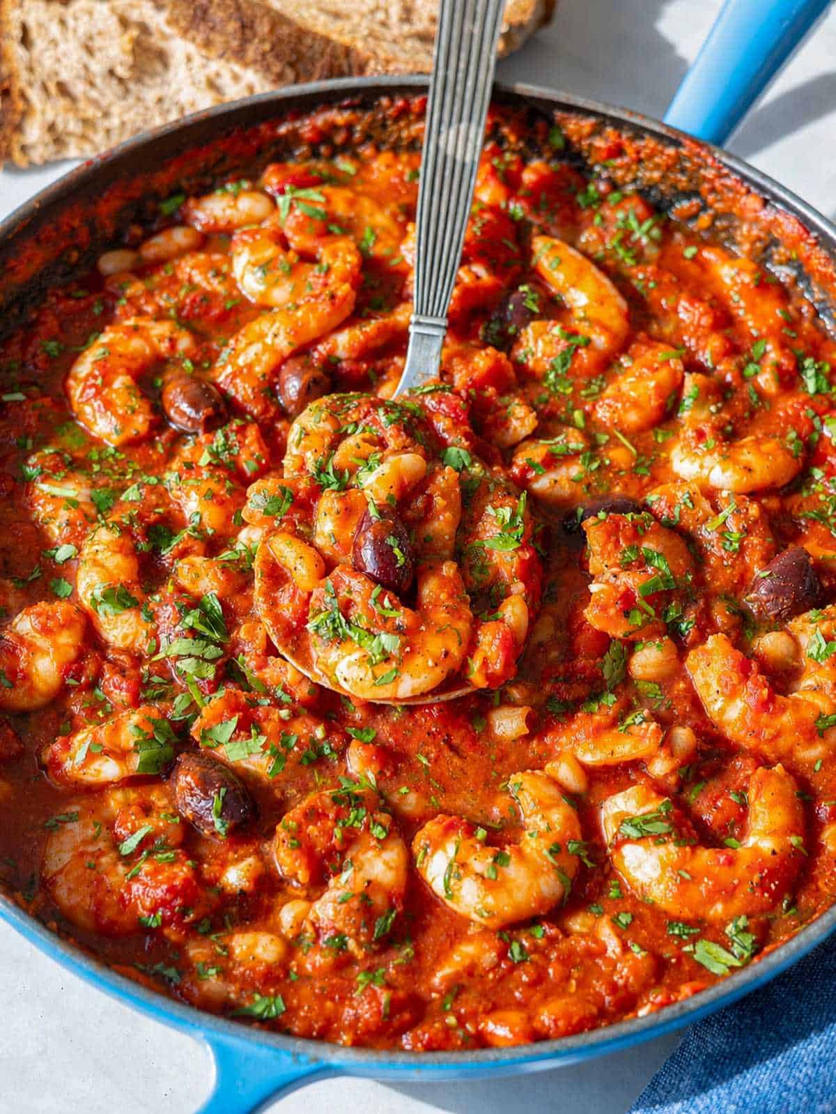Close-up shrimp in rich tomato sauce.