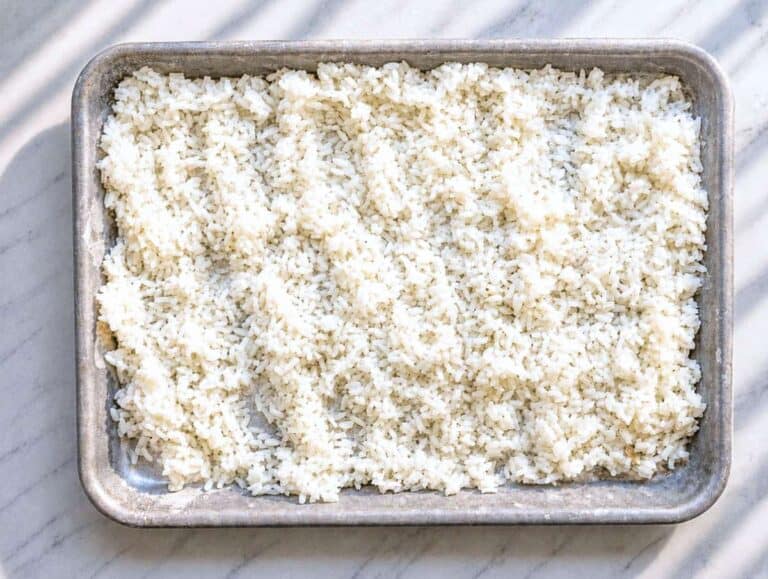 Step 1 Cooked white rice cooling on marble platter.