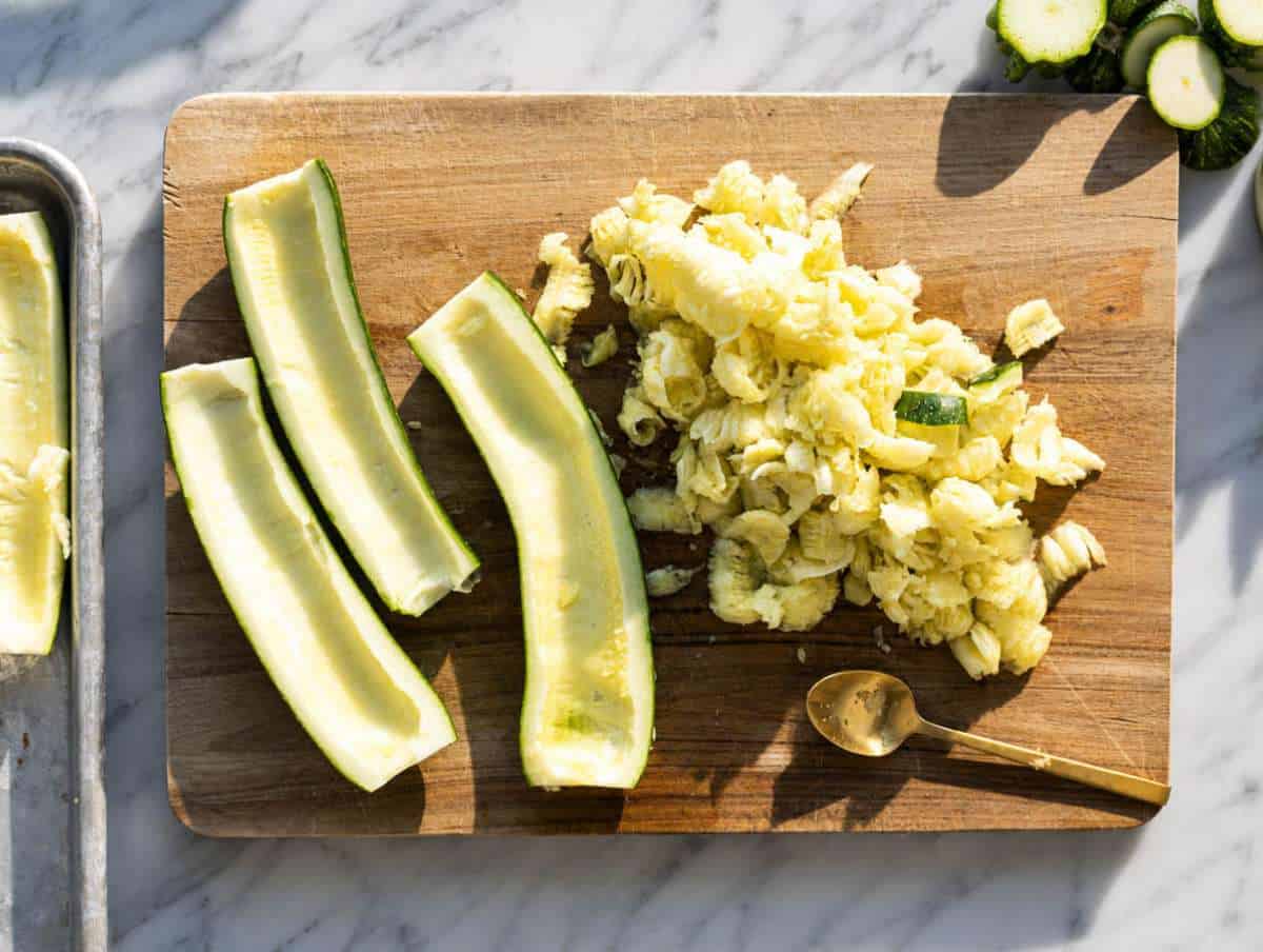 Step 1 Halved zucchini with centers scooped out and chopped zucchini flesh set aside.