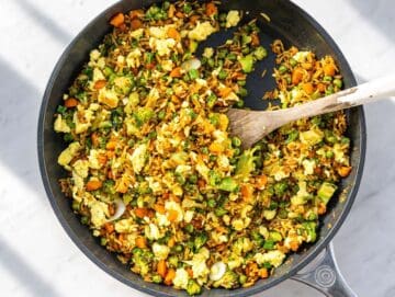 Step 3 Scrambled eggs folded into fried rice with sliced green onions.