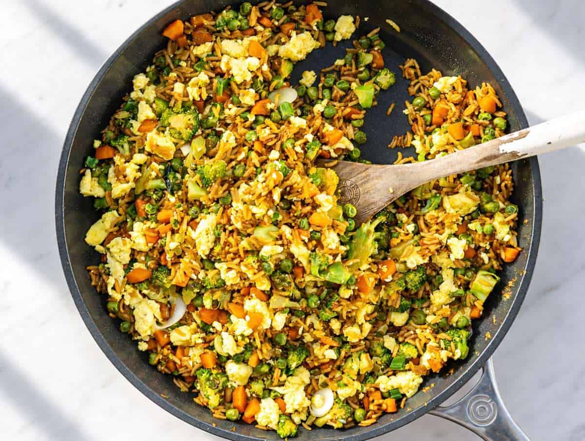 Step 3 Scrambled eggs folded into fried rice with sliced green onions.