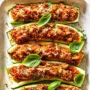 Turkey zucchini boats served warm in baking dish with fresh basil and lemon zest.
