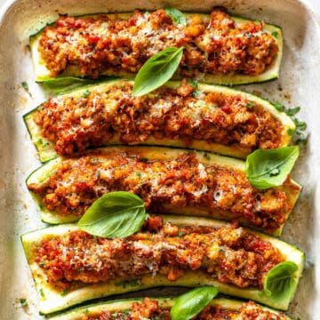 Turkey zucchini boats served warm in baking dish with fresh basil and lemon zest.